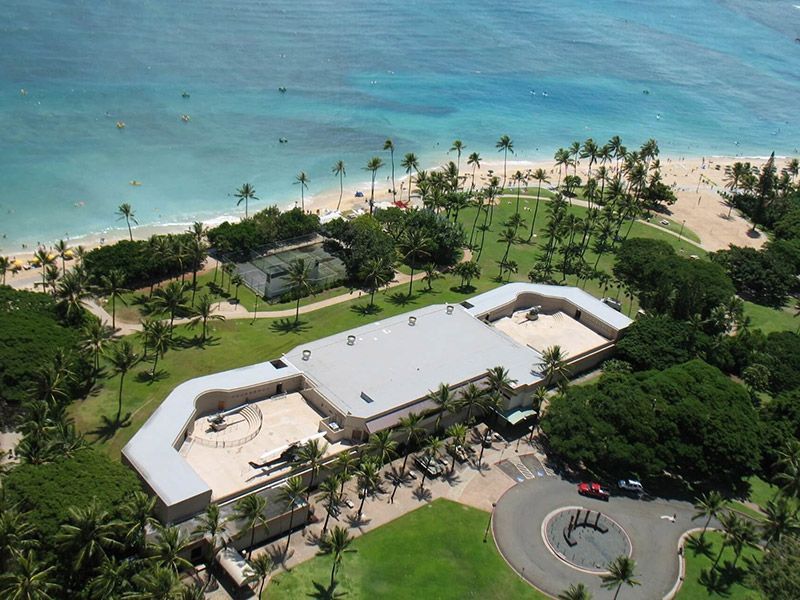 An aerial view of a large building next to the ocean