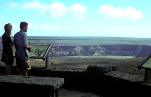 A man and a woman are looking out over a large body of water.