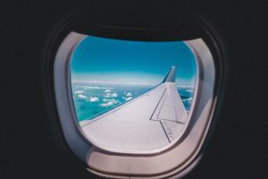 A view of the wing of an airplane through the window.