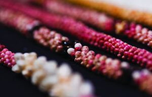 A close up of a bunch of necklaces on a table.