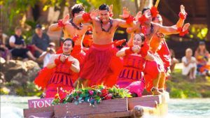 A group of people are dancing on a boat in the water.