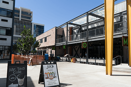 A sign for mr. tea cafe is sitting in front of a building.