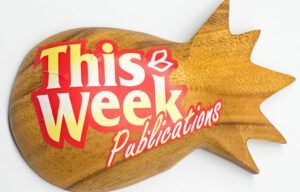 A wooden sign that says this week publications on it