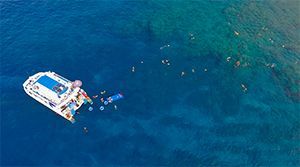 An aerial view of a boat floating on top of a body of water.