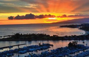 A sunset over a body of water with boats in the water