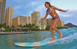 A woman in a bikini is riding a wave on a surfboard.