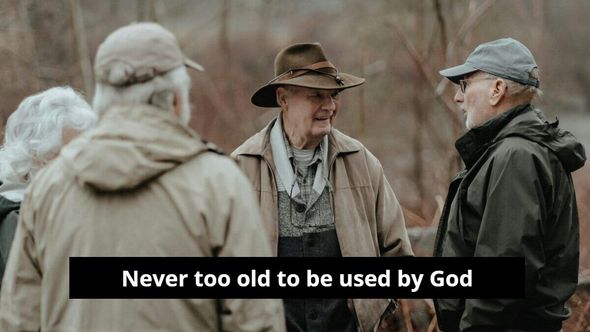 A group of older men are standing next to each other and talking.