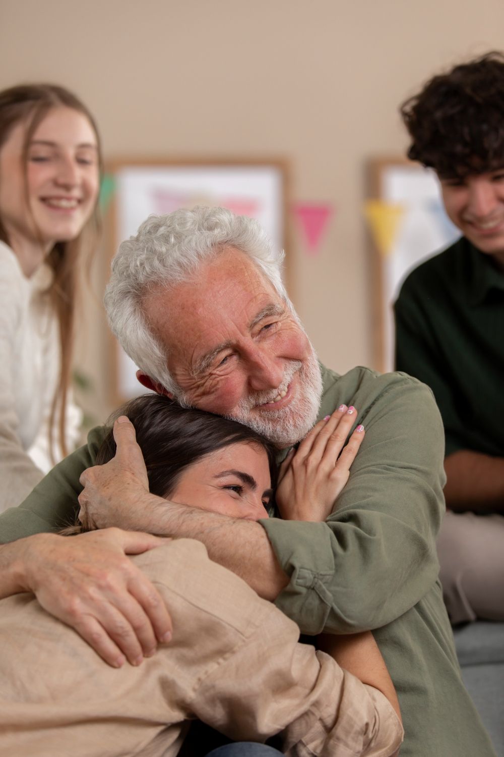 A man is hugging a woman in front of a group of people.