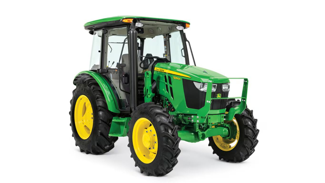 A green and yellow John Deere 5060E utility tractor with a cab, shown from a front-side angle on a white background.