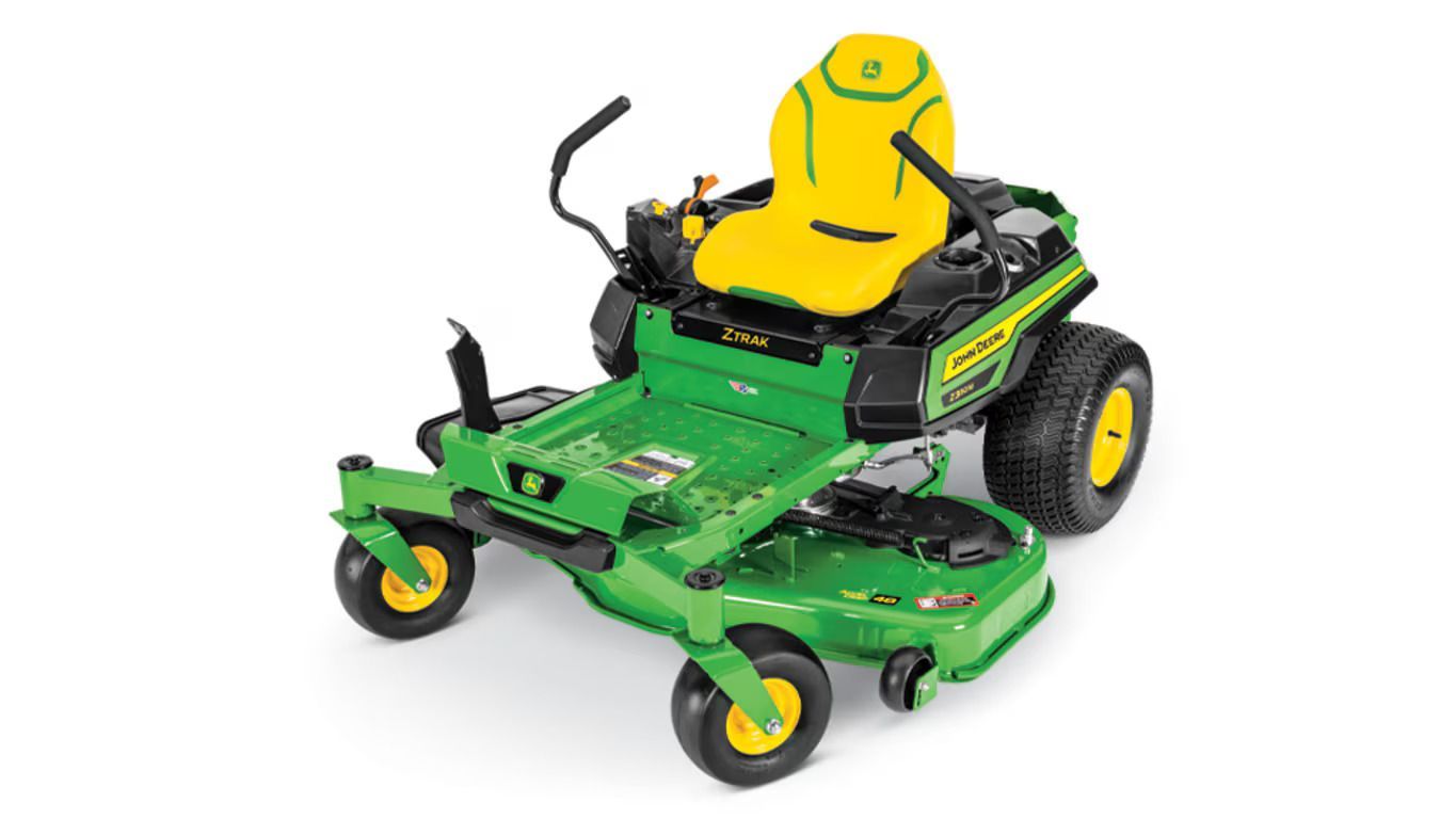 A green and yellow John Deere Z330M zero-turn riding lawn mower on a white background.
