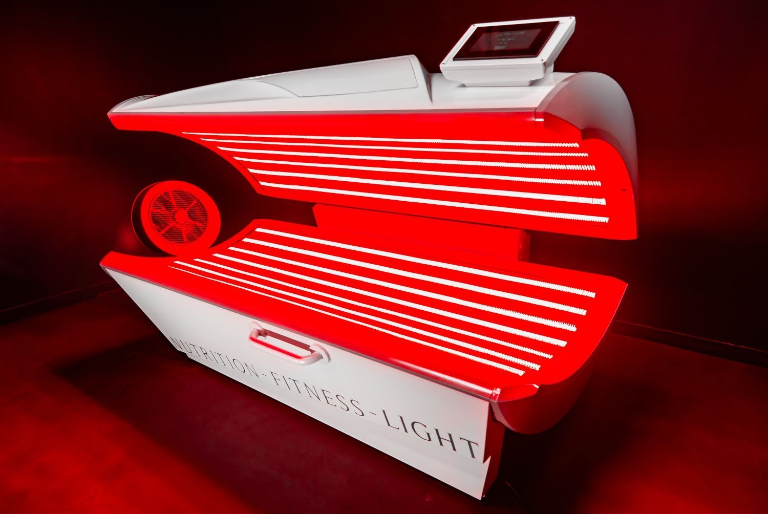 Red light therapy machine, white and red with a control panel.