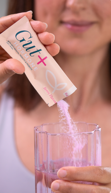 A person pours pink powder from a