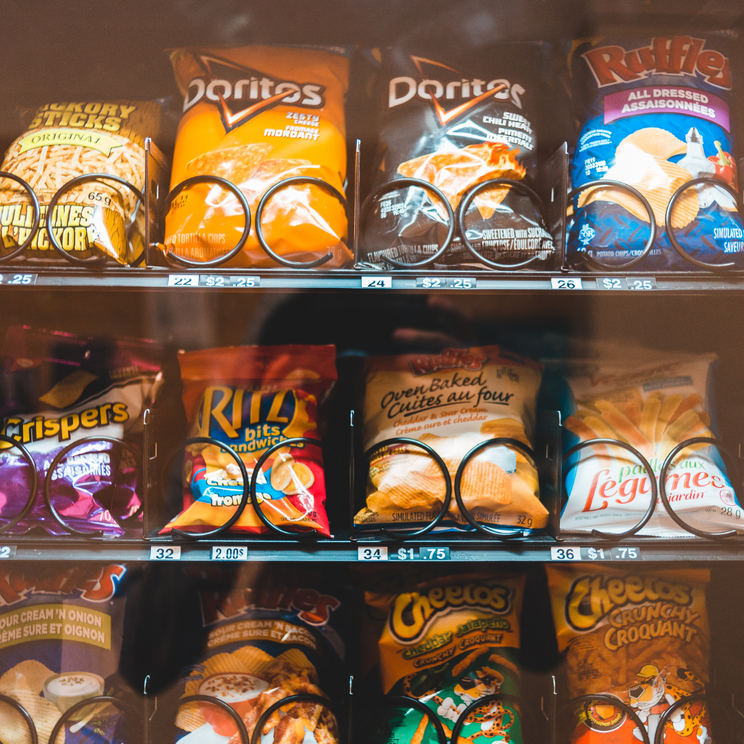 Assorted snack chips and crackers on store shelves
