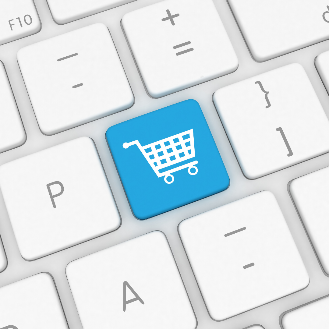 Blue shopping cart key on a white keyboard