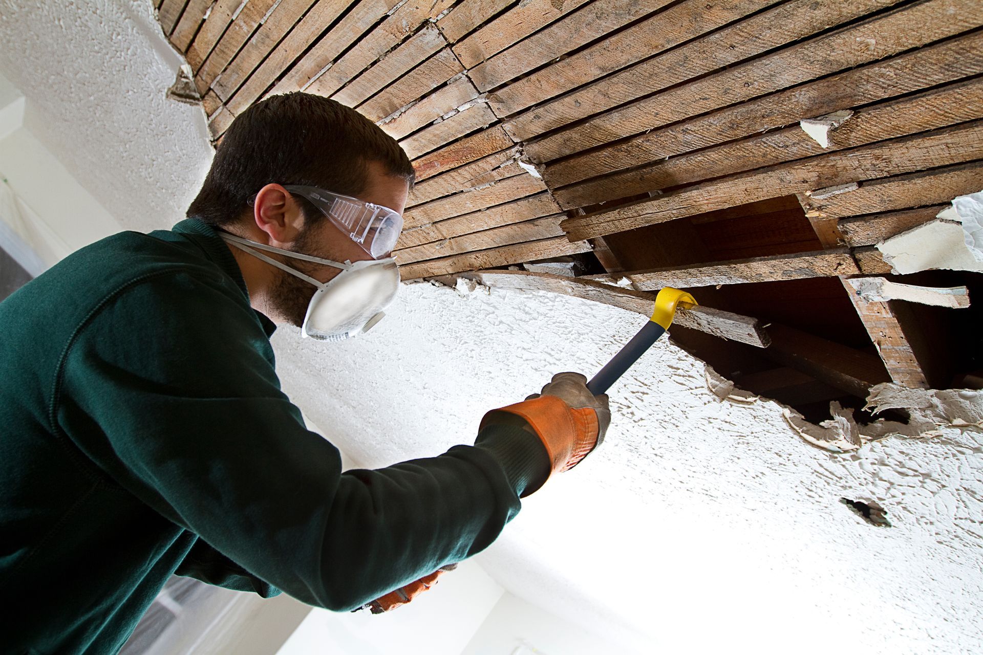 Professional worker repairing a ceiling corner during a drywall service in Moreno Valley, CA.