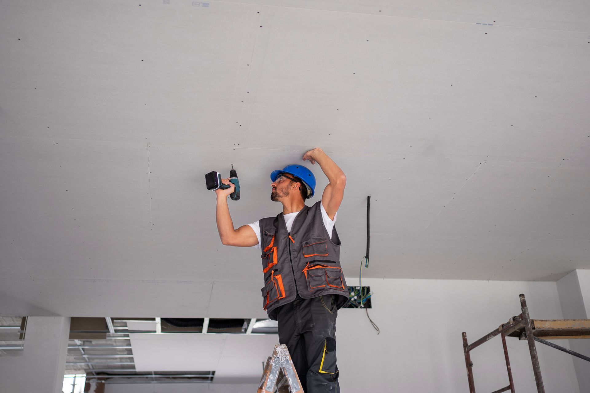 Construction worker installing a large panel during a drywall service in Moreno Valley, CA.