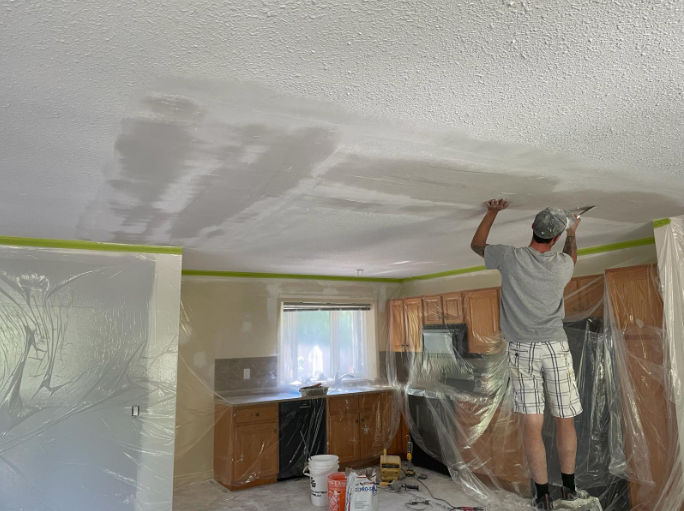 Interior of a room under construction, with drywall installed on walls and ceiling.