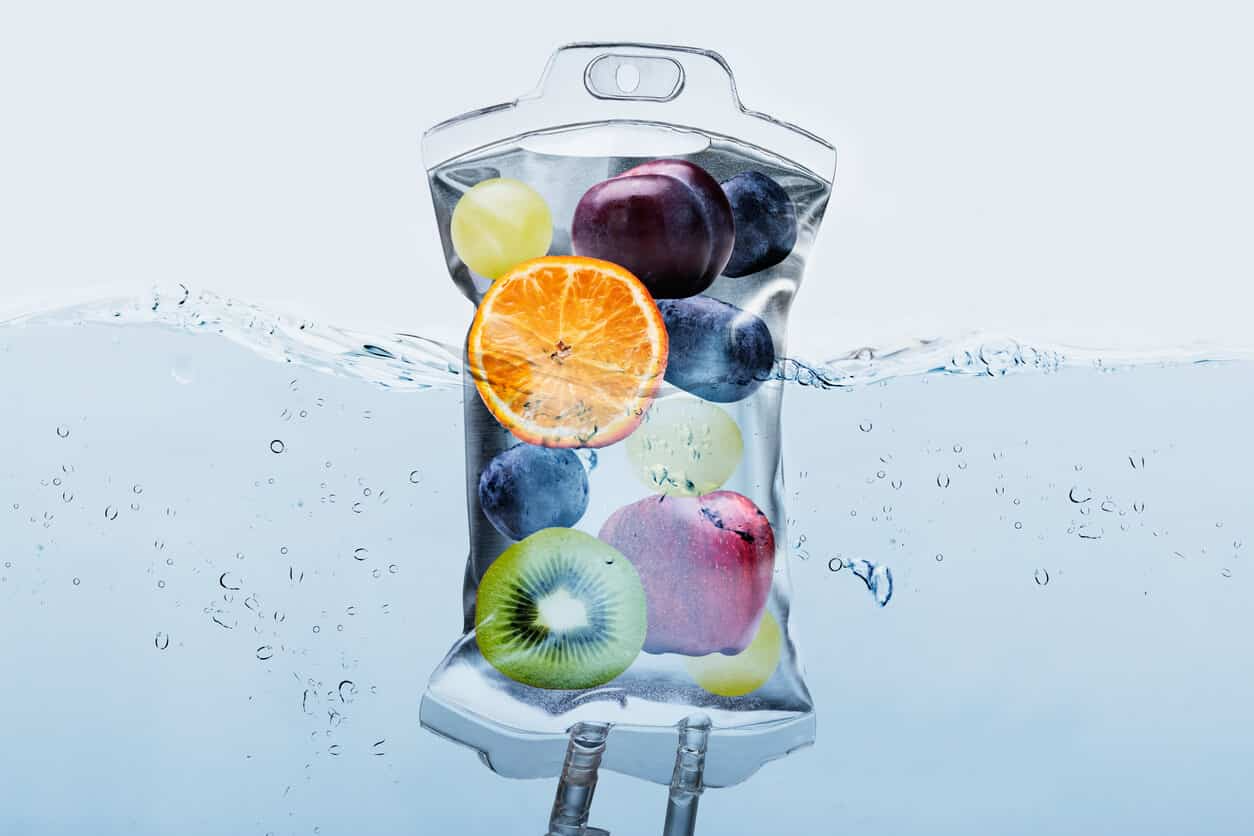 A bag of fruit is floating in water.