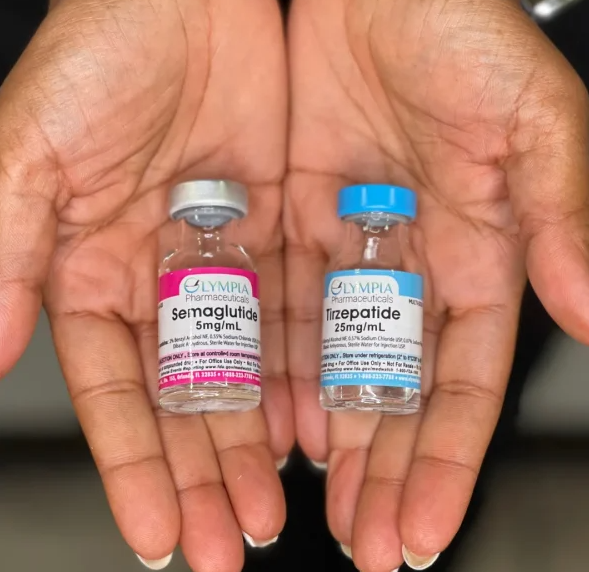 A person is holding two bottles of semaglutide and ineposide