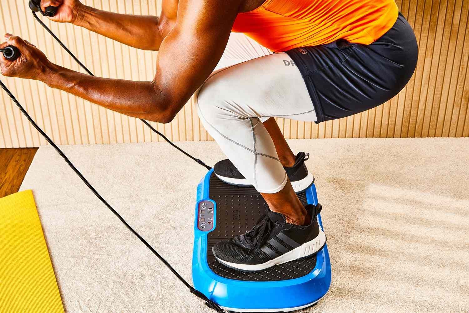A man is squatting on a vibration machine.