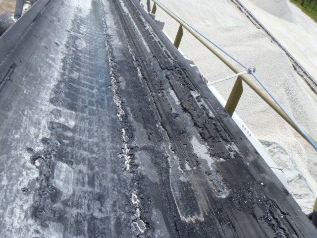 a close up of a damaged conveyor belt 