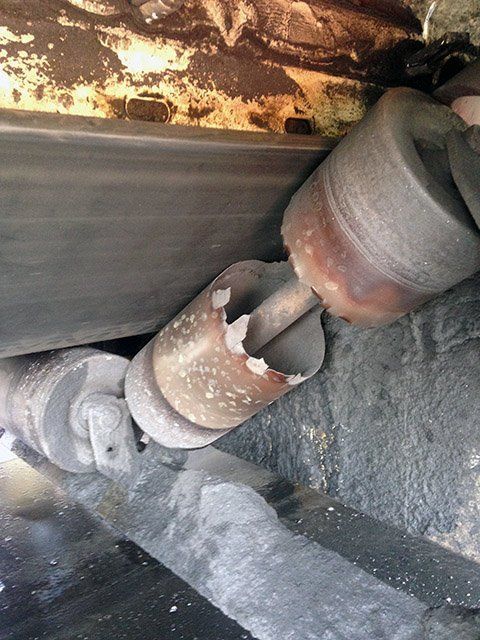 a close up of a piece of failed idler with a hole in it