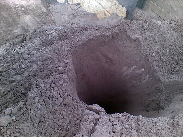 a hole in the ground with a hole in the middle of it