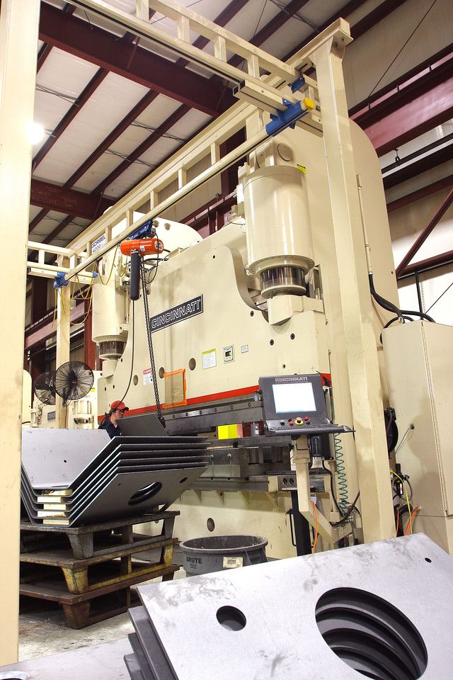 Large industrial metal stamping machine in a factory.