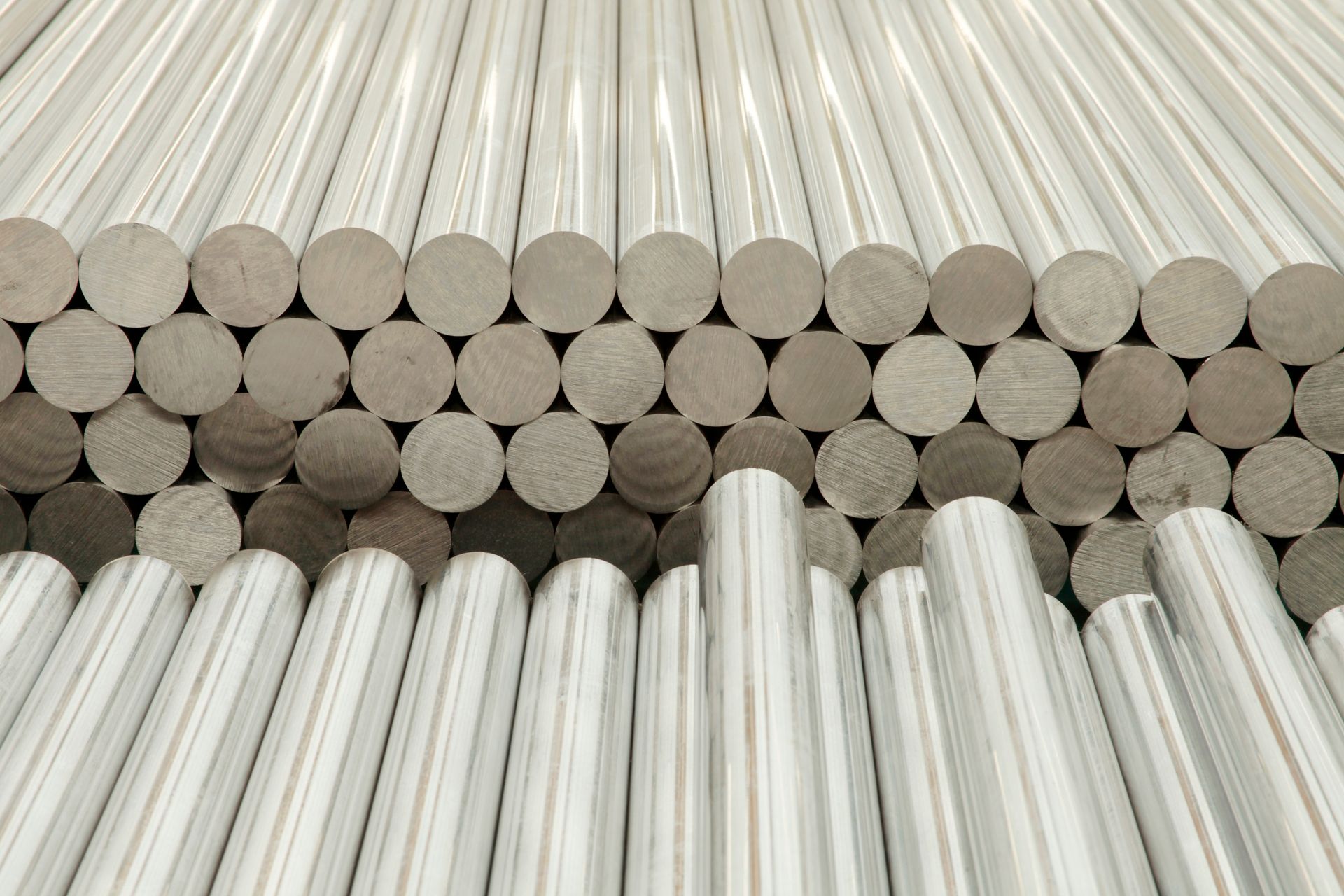 Rows of cylindrical wooden dowels, stacked in an organized pattern.