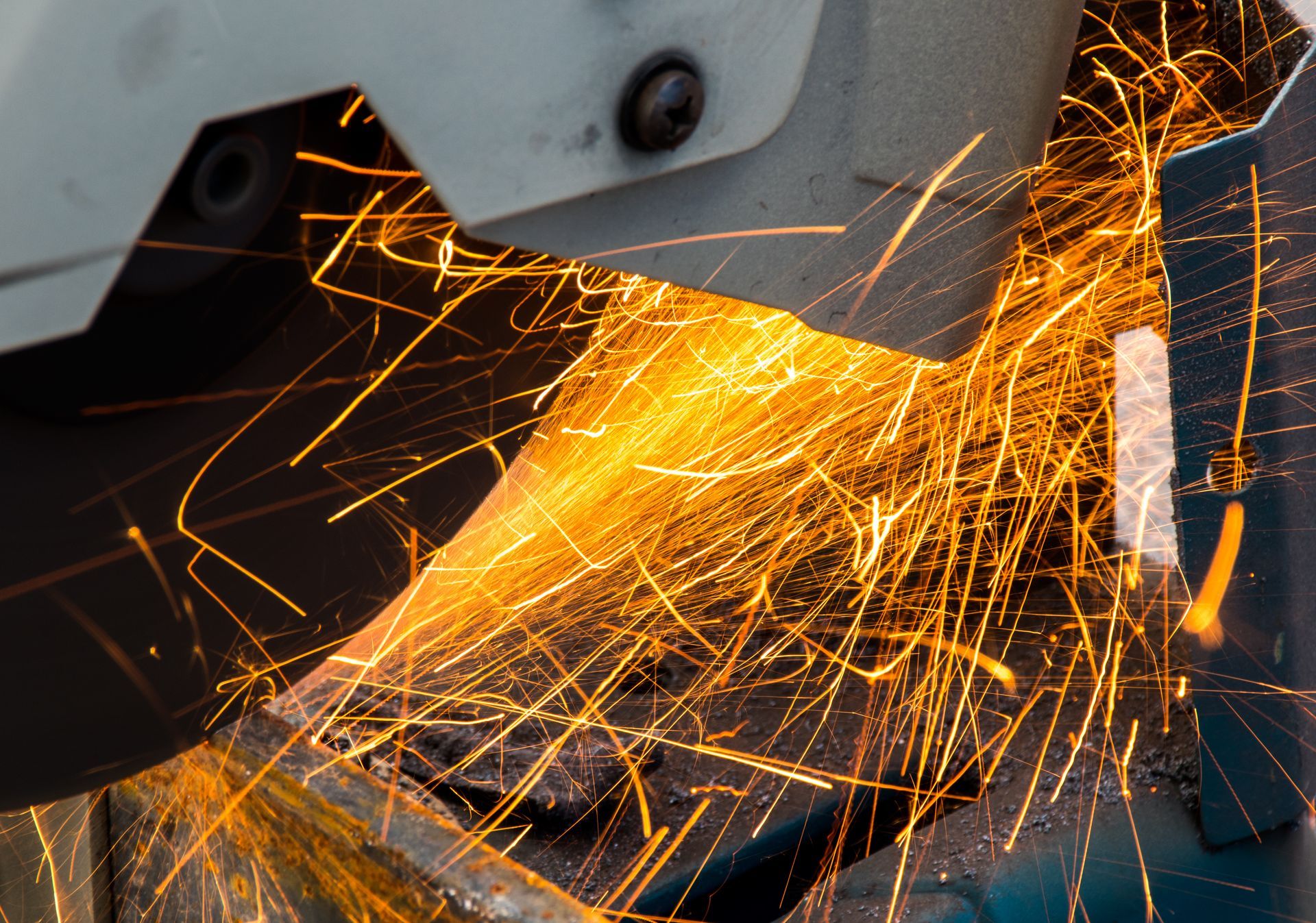 Sparks flying from a metal cutting saw in a close-up shot.