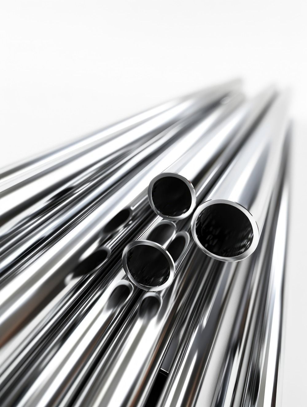 Shiny, silver metal tubes, arranged in a pile, with open circular ends.