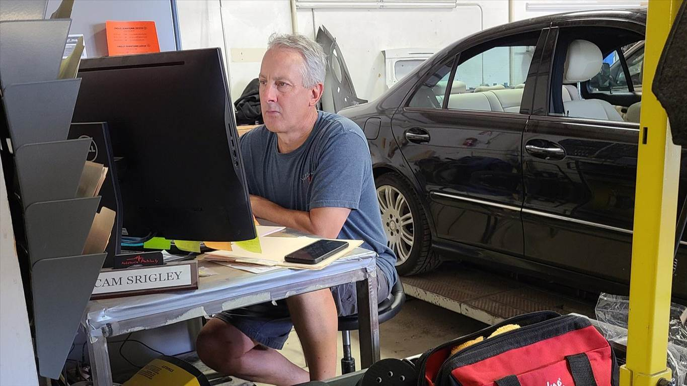 Cam Srigly hard at work using on of our many programs in assisting with auto repair