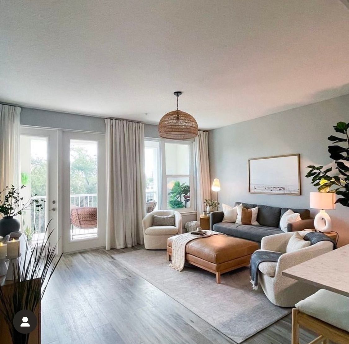 A living room with a couch and chairs and a table