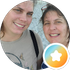 Two smiling women in a circular selfie, with a small orange star icon in the corner
