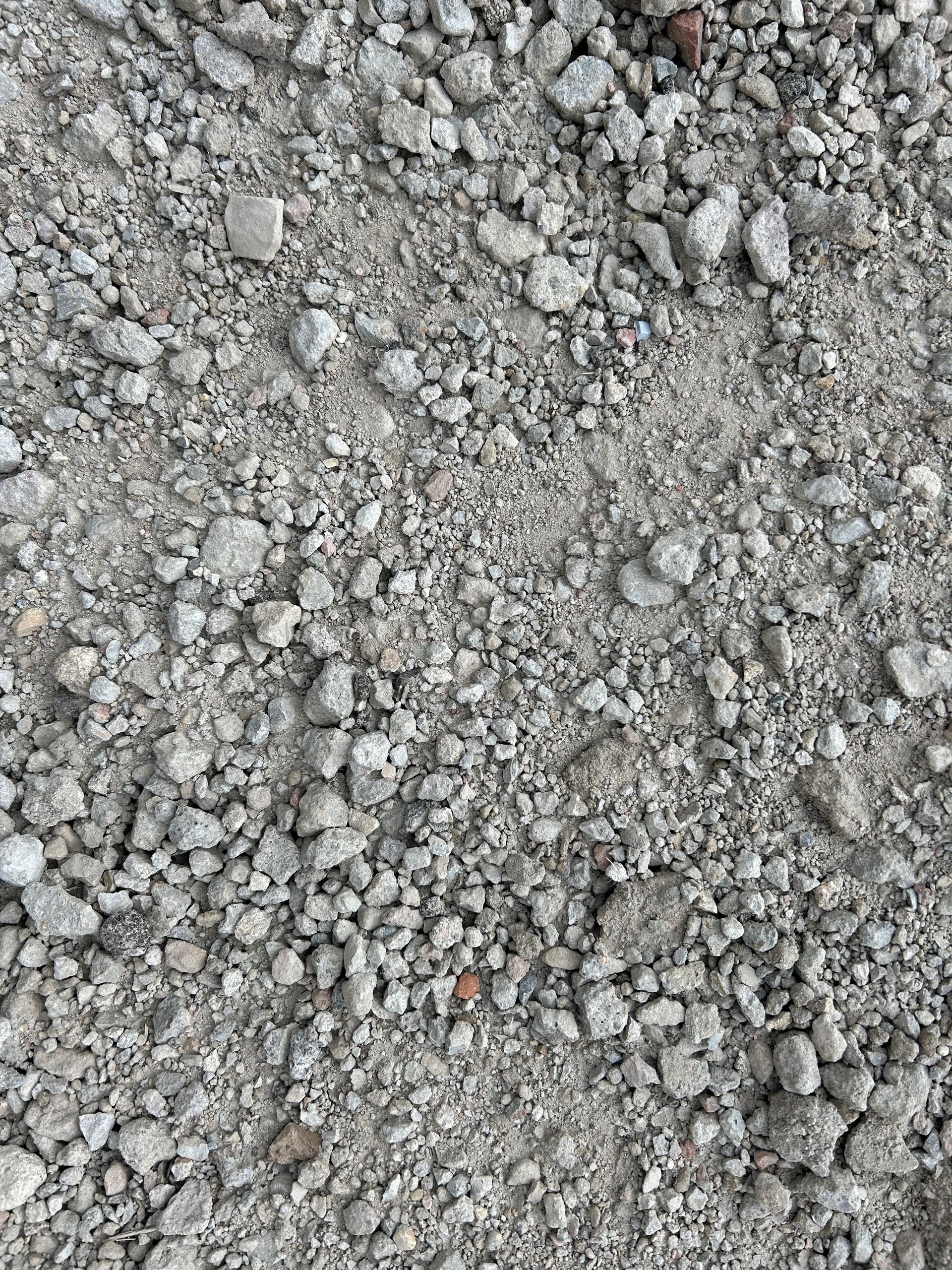 Gravel and small rocks on a gray-toned surface.