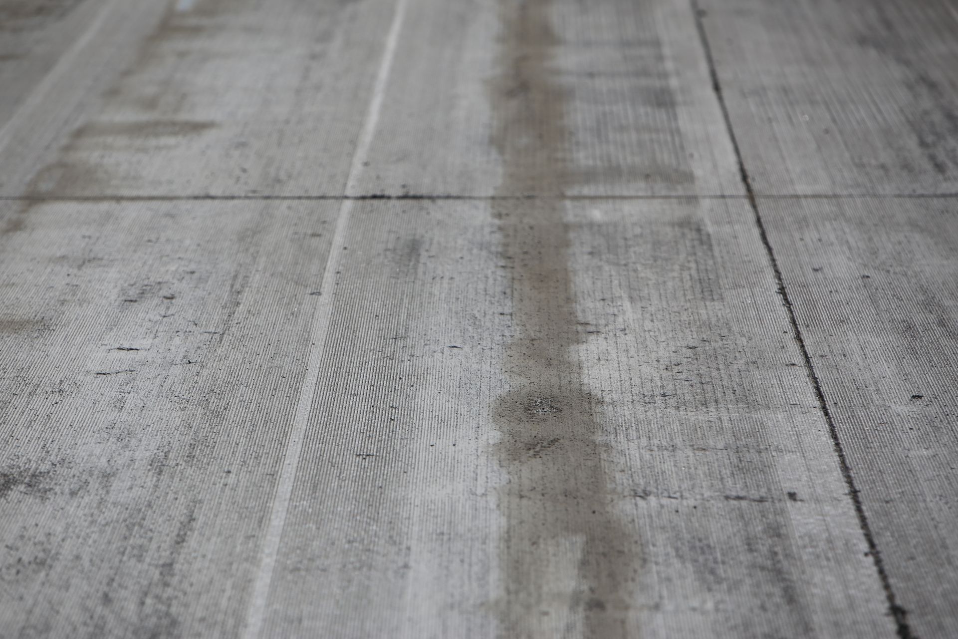 Gray concrete floor with visible wood grain texture.