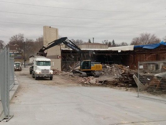 Orange bulldozer cleaning site from house breakdowns. Orange bulldozer cleaning site from house breakdowns.