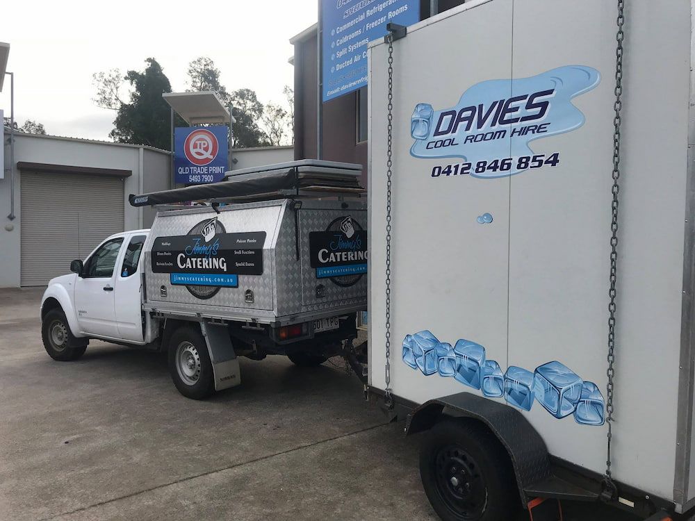 A White Truck With a Trailer Attached to It — Davies Refrigeration & Air Conditioning in Warana, QLD