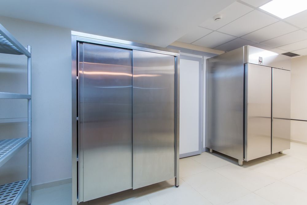 A Room Filled With Stainless Steel Refrigerators and Shelves — Davies Refrigeration & Air Conditioning in Warana, QLD