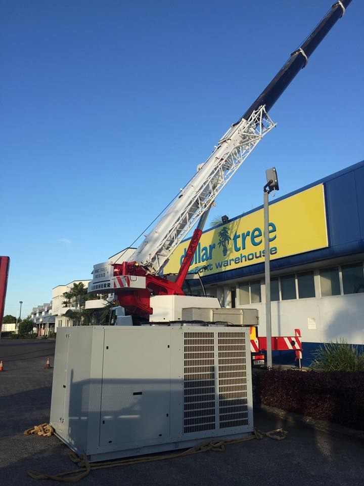 A Large Crane is in Front of a Dollar Tree Store — Davies Refrigeration & Air Conditioning in Warana, QLD