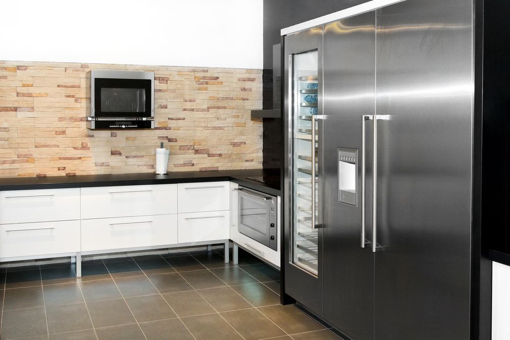 A Kitchen With a Stainless Steel Refrigerator and a Microwave — Davies Refrigeration & Air Conditioning in Warana, QLD