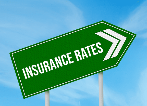 A green sign that says insurance rates on it