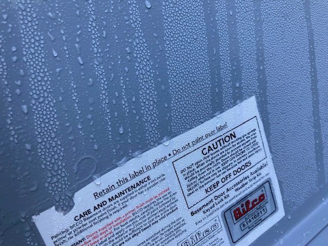 A close up of a sticker that says caution on it