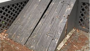 A close up of a wooden ramp with a lattice fence in the background.
