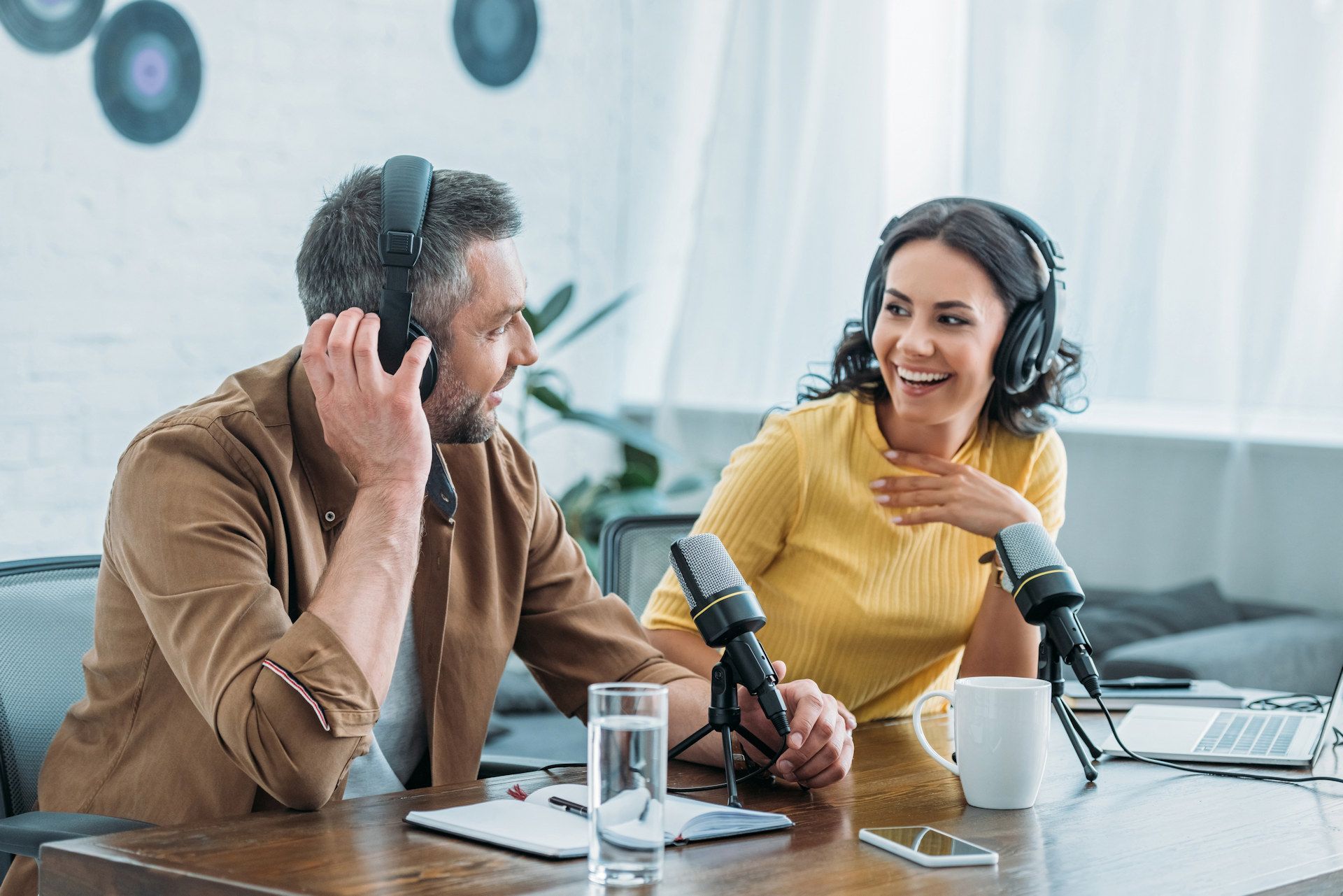 Man and women presenting a live radio show.