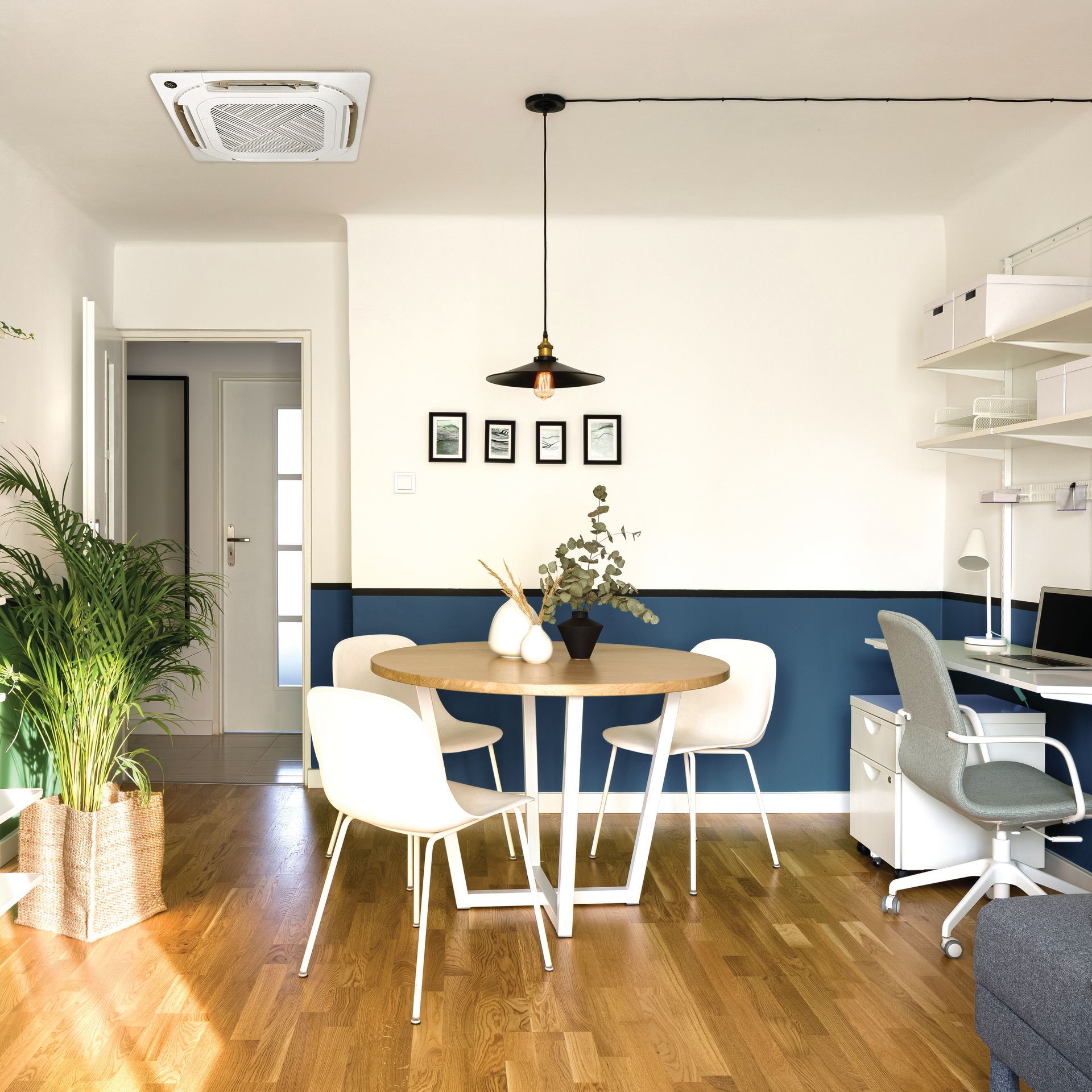 A living room with a round table and chairs