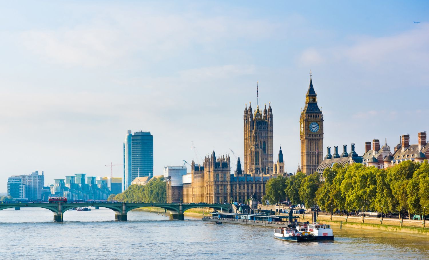 London skyline with Big Ben and Westminster Bridge along the River Thames on a sunny day