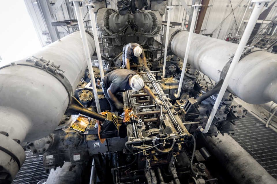 Two men are working on a power plant.