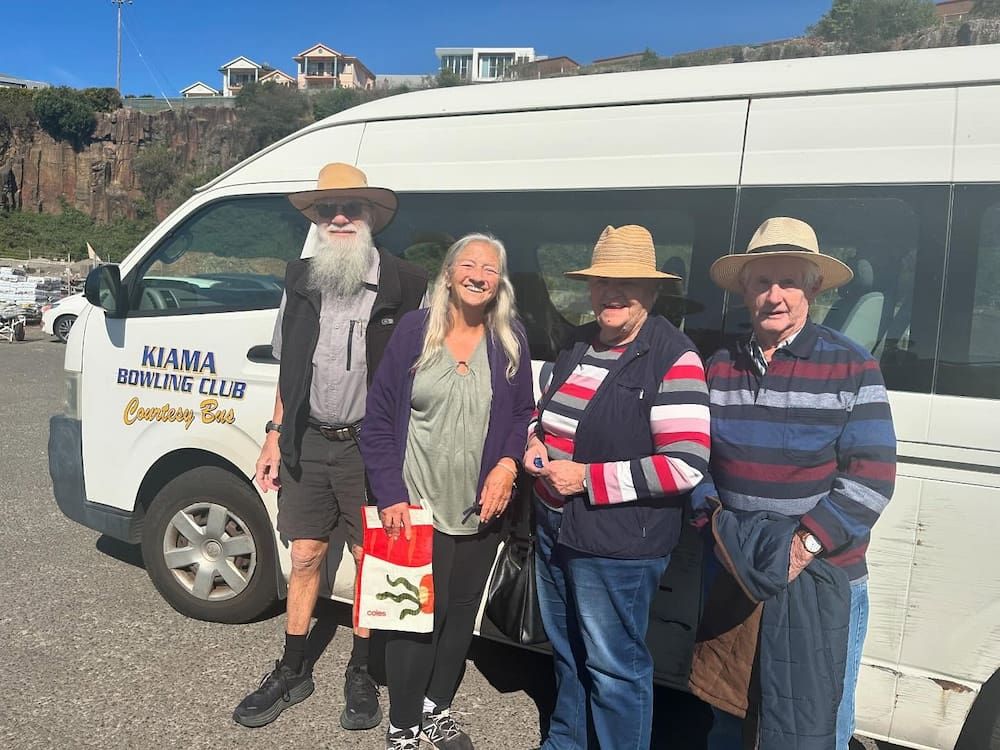 A Group Of People Are Standing In Front Of A White Van — Burnetts On Barney in Kiama, NSW