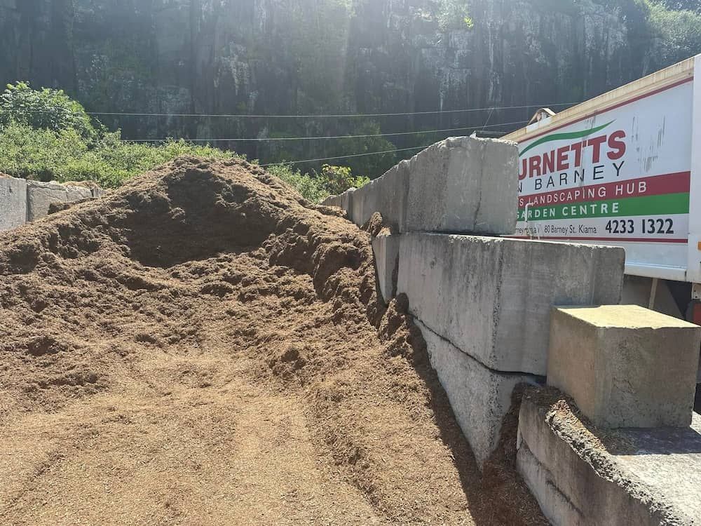 A Pile Of Dirt Is Sitting Next To A Sign — Burnetts On Barney in Minnamurra, NSW